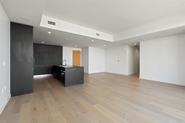44 E Ave Unit 4302, Austin, TX 78701 - unfurnished living room with light wood-style flooring and recessed lighting