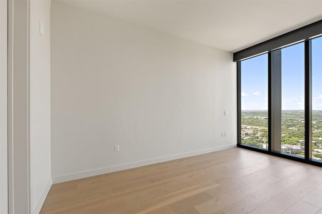 44 E Ave Unit 4302, Austin, TX 78701 - unfurnished room with floor to ceiling windows and light wood-type flooring