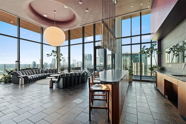 44 E Ave Unit 2307, Austin, TX 78701 - lobby featuring floor to ceiling windows, a sink, a skyline view, a towering ceiling, and recessed lighting
