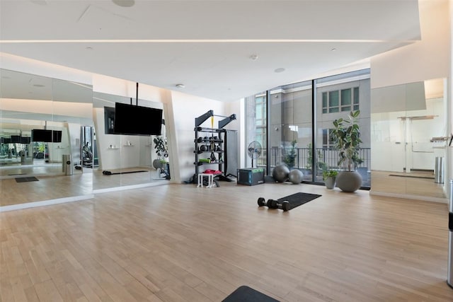 44 E Ave Unit 2307, Austin, TX 78701 - gym featuring floor to ceiling windows and light wood-type flooring