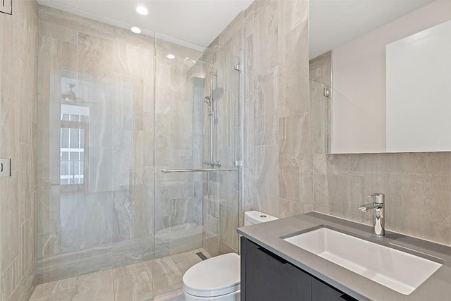 44 E Ave Unit 2307, Austin, TX 78701 - full bath featuring toilet, vanity, a shower stall, tile walls, and recessed lighting