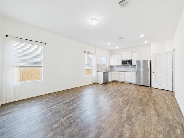 3113 Windy Vane Dr, Pflugerville, TX 78660 - unfurnished living room with wood finished floors, recessed lighting, and baseboards
