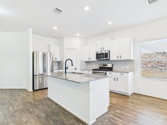 3113 Windy Vane Dr, Pflugerville, TX 78660 - kitchen featuring appliances with stainless steel finishes, a sink, wood finished floors, backsplash, and recessed lighting