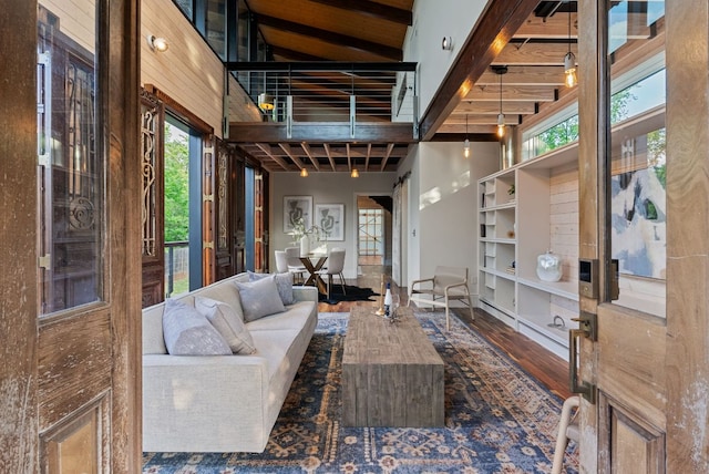 5607 Jim Hogg Ave, Austin, TX 78756 - living area featuring wood finished floors, a high ceiling, healthy amount of natural light, and beam ceiling