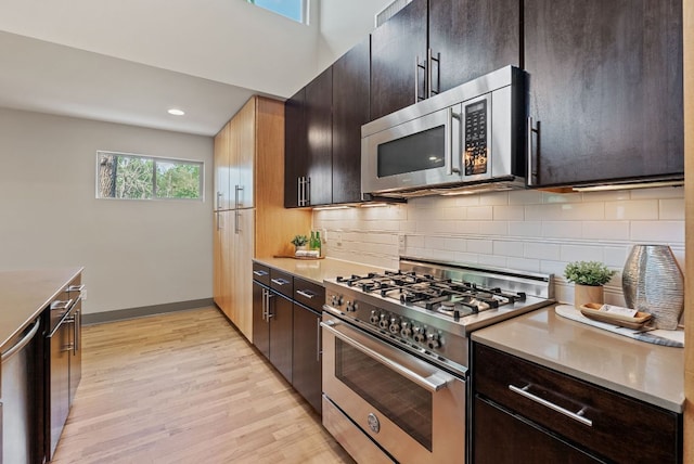 5607 Jim Hogg Ave, Austin, TX 78756 - kitchen featuring stainless steel appliances, light wood-style floors, backsplash, light countertops, and recessed lighting