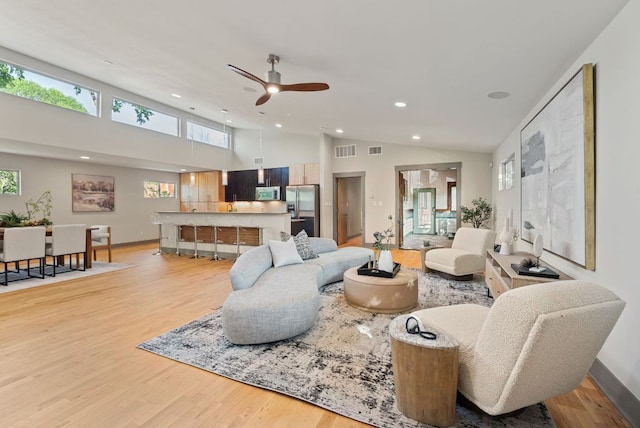 5607 Jim Hogg Ave, Austin, TX 78756 - living room with a ceiling fan, light wood-style flooring, recessed lighting, baseboards, and high vaulted ceiling