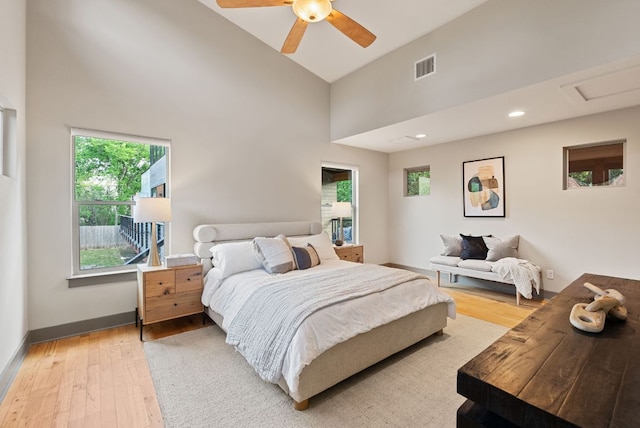 5607 Jim Hogg Ave, Austin, TX 78756 - bedroom featuring light wood-type flooring, high vaulted ceiling, baseboards, attic access, and ceiling fan