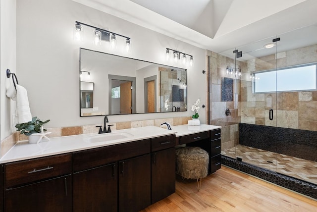 5607 Jim Hogg Ave, Austin, TX 78756 - bathroom featuring a stall shower, vanity, and wood finished floors