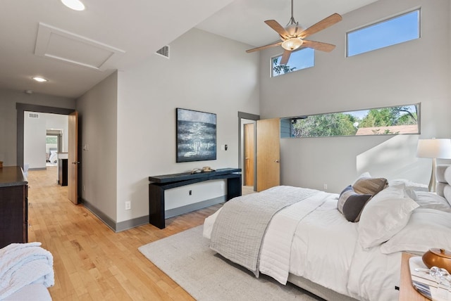 5607 Jim Hogg Ave, Austin, TX 78756 - bedroom featuring attic access, light wood-style flooring, baseboards, a high ceiling, and recessed lighting