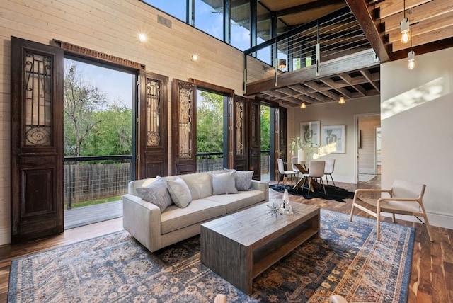 5607 Jim Hogg Ave, Austin, TX 78756 - living area with a high ceiling, wood finished floors, and baseboards