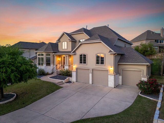 17012 Rush Pea Cir, Austin, TX 78738 - french country inspired facade featuring stucco siding, concrete driveway, stone siding, roof with shingles, and a garage