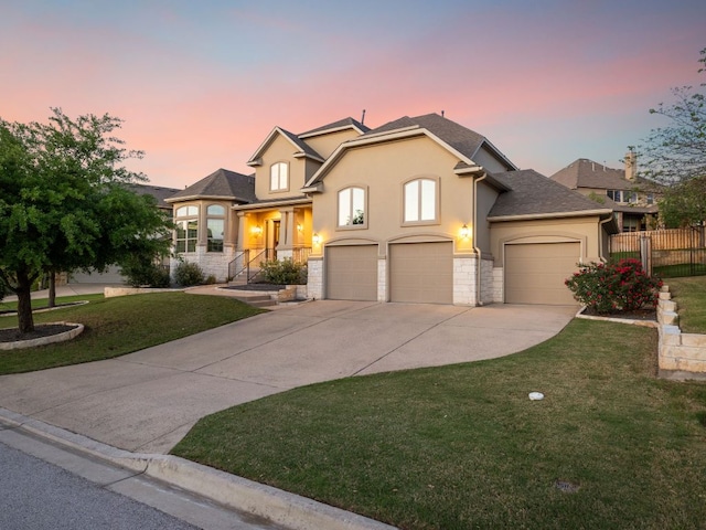 17012 Rush Pea Cir, Austin, TX 78738 - view of front of house with stucco siding, driveway, stone siding, and an attached garage