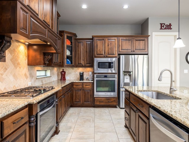 17012 Rush Pea Cir, Austin, TX 78738 - kitchen featuring appliances with stainless steel finishes, a sink, light stone counters, tasteful backsplash, and recessed lighting