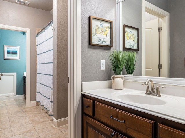 17012 Rush Pea Cir, Austin, TX 78738 - full bath with vanity, tile patterned floors, a textured wall, and a shower with shower curtain