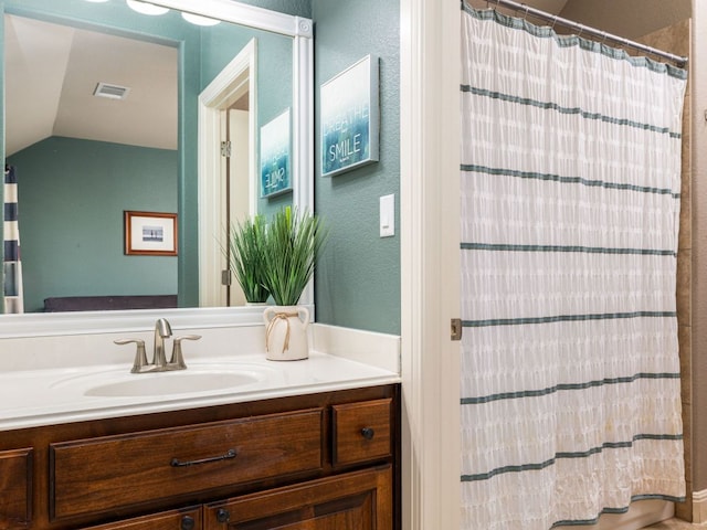 17012 Rush Pea Cir, Austin, TX 78738 - bathroom with vanity, lofted ceiling, a shower with curtain, and a textured wall