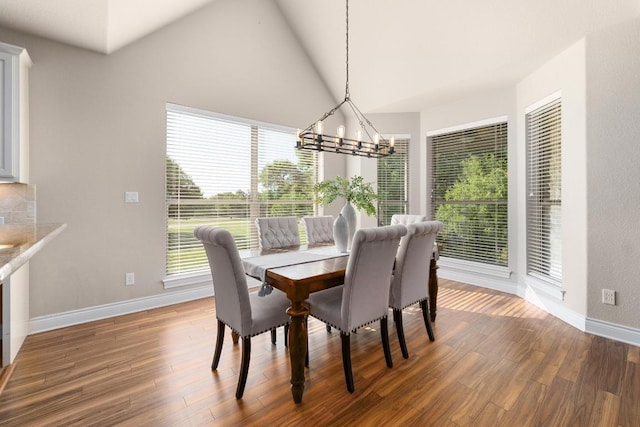404 Oak Meadow Dr, Georgetown, TX 78628 - dining area with a chandelier, wood finished floors, and lofted ceiling