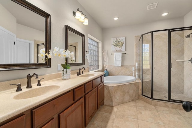 404 Oak Meadow Dr, Georgetown, TX 78628 - full bathroom with a bath, a shower stall, double vanity, tile patterned floors, and recessed lighting