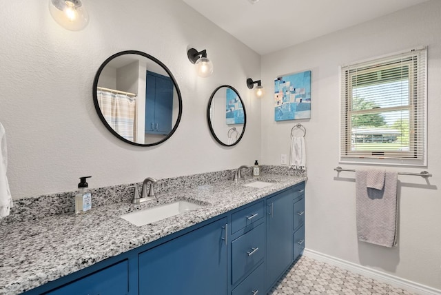 1707 Aztec Trl, Kingsland, TX 78639 - full bathroom with tile patterned floors, double vanity, and baseboards