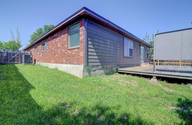 233 Devonshire Dr, Kyle, TX 78640 - view of side of home featuring a wooden deck and cooling unit