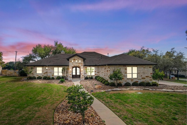 209 Aldea St, Georgetown, TX 78633 - french country home featuring stone siding, french doors, a front lawn, and roof with shingles