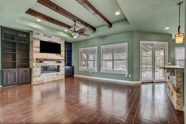 209 Aldea St, Georgetown, TX 78633 - unfurnished living room featuring a fireplace, a ceiling fan, dark wood-style floors, beam ceiling, and recessed lighting