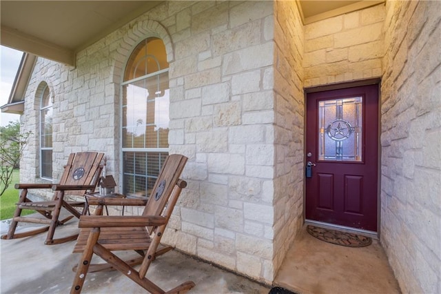 doorway to property with stone siding