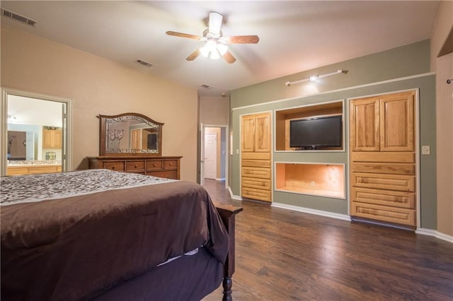 bedroom featuring visible vents, baseboards, connected bathroom, and dark wood-style floors