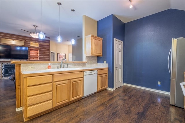 kitchen with white dishwasher, a sink, open floor plan, ceiling fan, and freestanding refrigerator