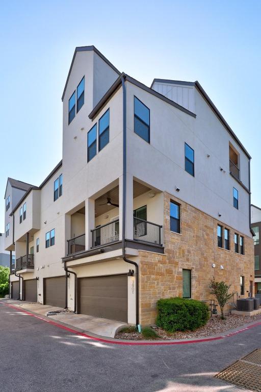 exterior space featuring central AC and an attached garage