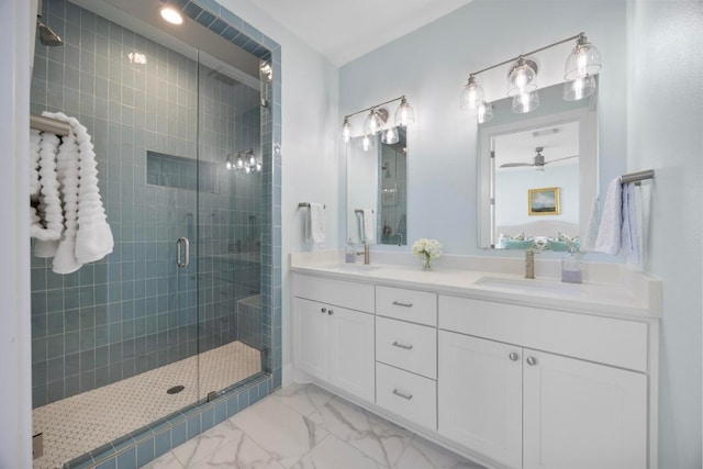 full bathroom featuring double vanity, marble finish floor, a sink, and a stall shower