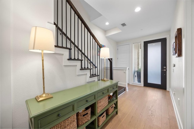 entryway with visible vents, stairway, recessed lighting, light wood finished floors, and baseboards