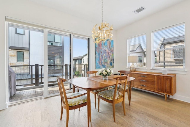 3901 Vantage Dr, Austin, TX 78731 - dining room featuring light wood-style floors, a chandelier, and baseboards