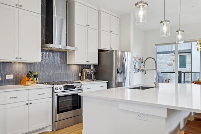 3901 Vantage Dr, Austin, TX 78731 - kitchen with stainless steel appliances, wall chimney exhaust hood, a sink, and light countertops