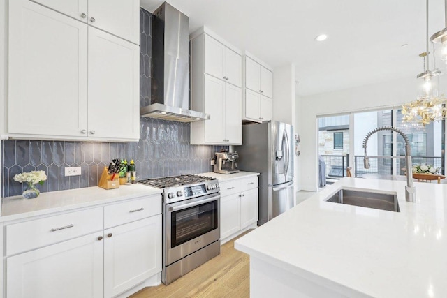 3901 Vantage Dr, Austin, TX 78731 - kitchen featuring stainless steel appliances, wall chimney range hood, a sink, white cabinetry, and recessed lighting