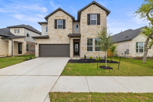 traditional-style house with a front yard, driveway, stone siding, and a garage