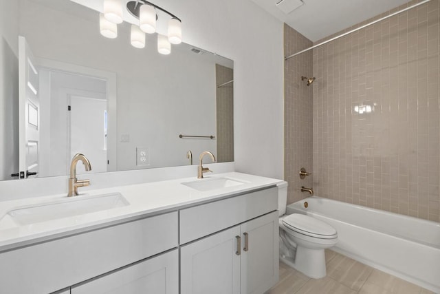 bathroom with a sink, toilet, double vanity, and shower / bathtub combination