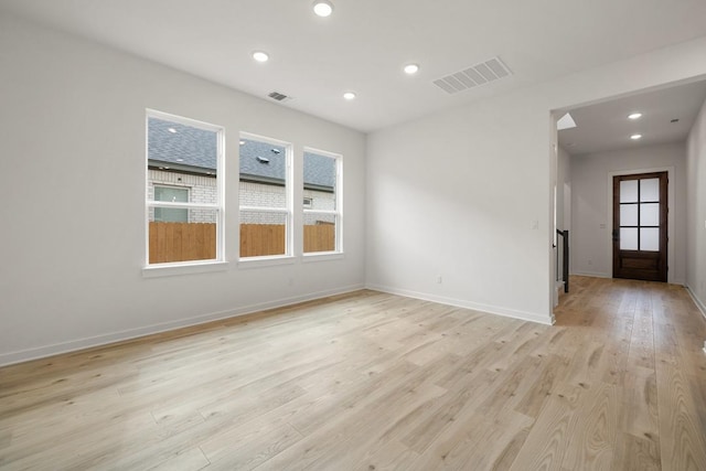 spare room featuring visible vents, baseboards, recessed lighting, and light wood-style floors