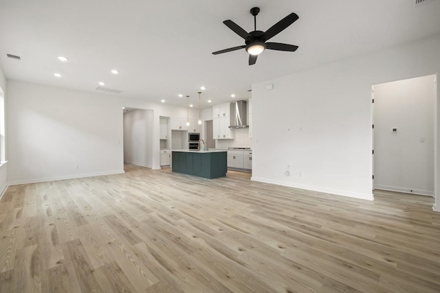 unfurnished living room featuring light wood-style floors, recessed lighting, visible vents, and a ceiling fan