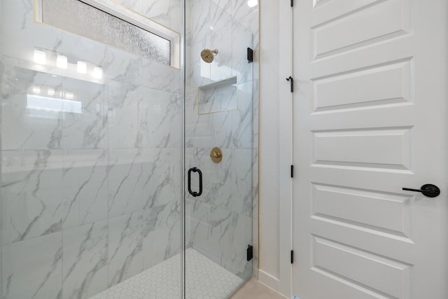 full bathroom with a marble finish shower