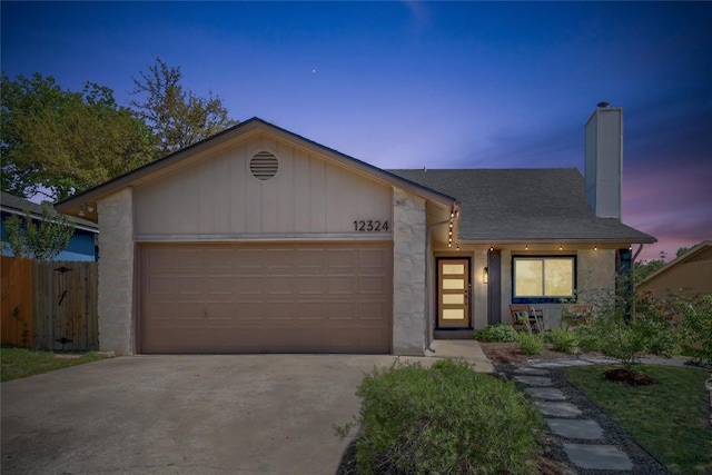 12324 Havelock Dr, Austin, TX 78759 - view of front of property with a chimney, a garage, driveway, roof with shingles, and stone siding