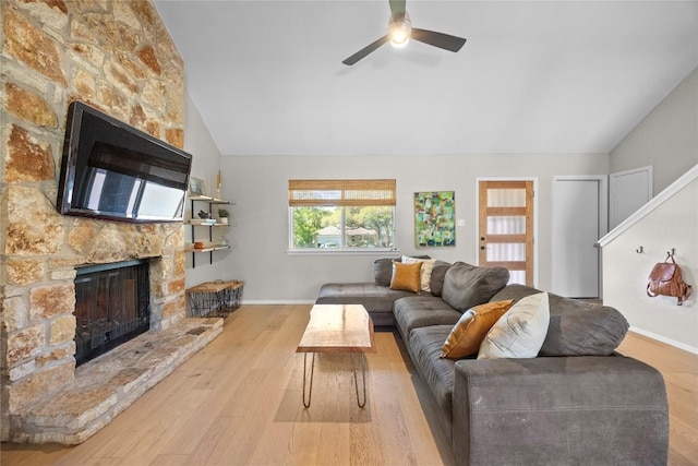 12324 Havelock Dr, Austin, TX 78759 - living room featuring a stone fireplace, vaulted ceiling, ceiling fan, and wood finished floors