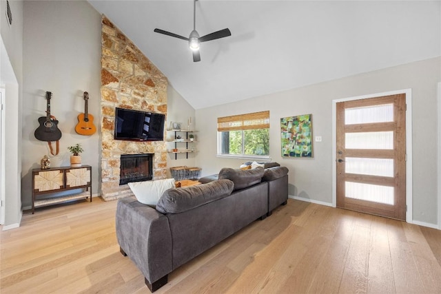 12324 Havelock Dr, Austin, TX 78759 - living area featuring light wood-style flooring, a ceiling fan, a stone fireplace, and high vaulted ceiling