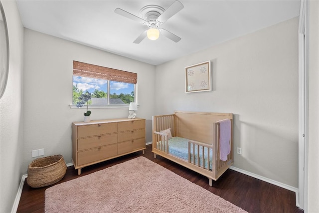 12324 Havelock Dr, Austin, TX 78759 - bedroom featuring dark wood-type flooring, ceiling fan, and a nursery area