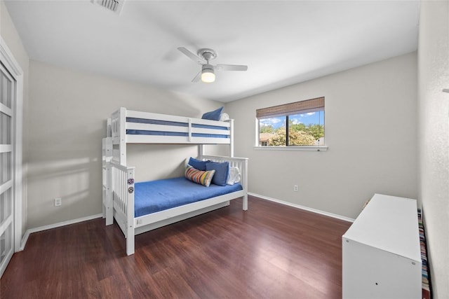 bedroom with a ceiling fan, visible vents, wood finished floors, and baseboards