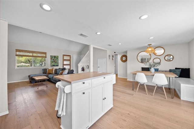 12324 Havelock Dr, Austin, TX 78759 - kitchen featuring white cabinetry, light countertops, open floor plan, light wood-style flooring, and recessed lighting