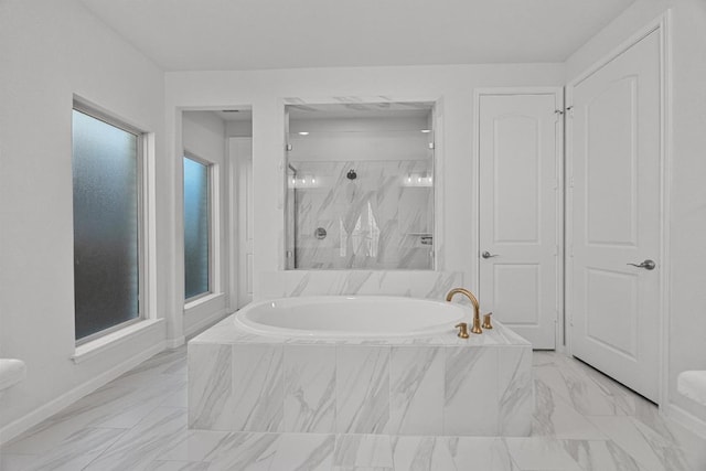 409 Dycus Bnd, Liberty Hill, TX 78642 - full bathroom with a garden tub, marble finish floors, a marble finish shower, and baseboards