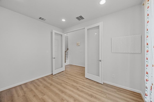 409 Dycus Bnd, Liberty Hill, TX 78642 - unfurnished bedroom featuring baseboards, light wood-style floors, recessed lighting, and french doors