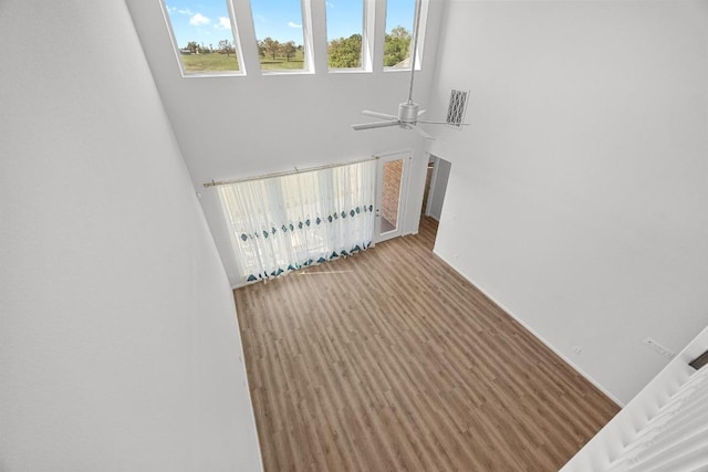 409 Dycus Bnd, Liberty Hill, TX 78642 - stairs with ceiling fan, a towering ceiling, and baseboards
