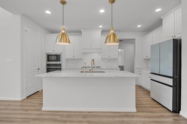 409 Dycus Bnd, Liberty Hill, TX 78642 - kitchen with freestanding refrigerator, built in microwave, stainless steel oven, white cabinetry, and recessed lighting