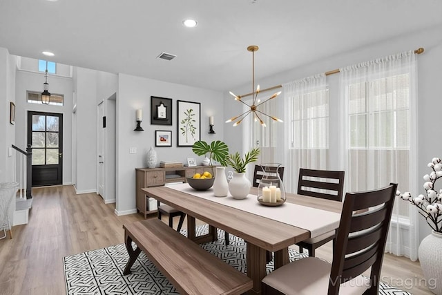 409 Dycus Bnd, Liberty Hill, TX 78642 - dining area with light wood-type flooring, baseboards, a chandelier, and recessed lighting